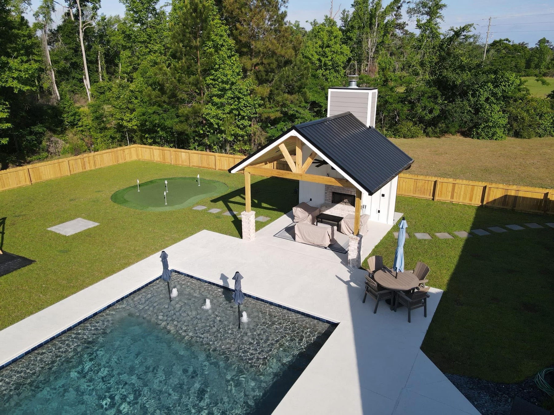 Pool, putting green, and pavilion, one backyard build