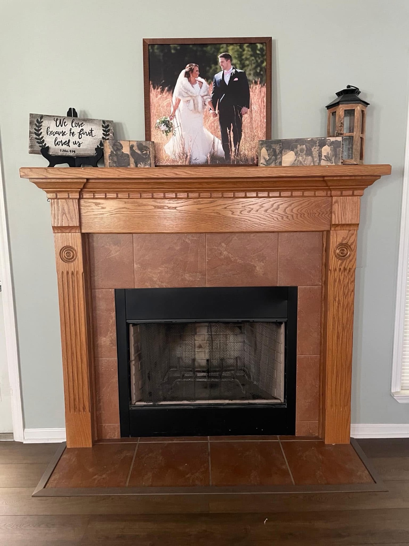 The fireplace before: oak mantel and tan tile