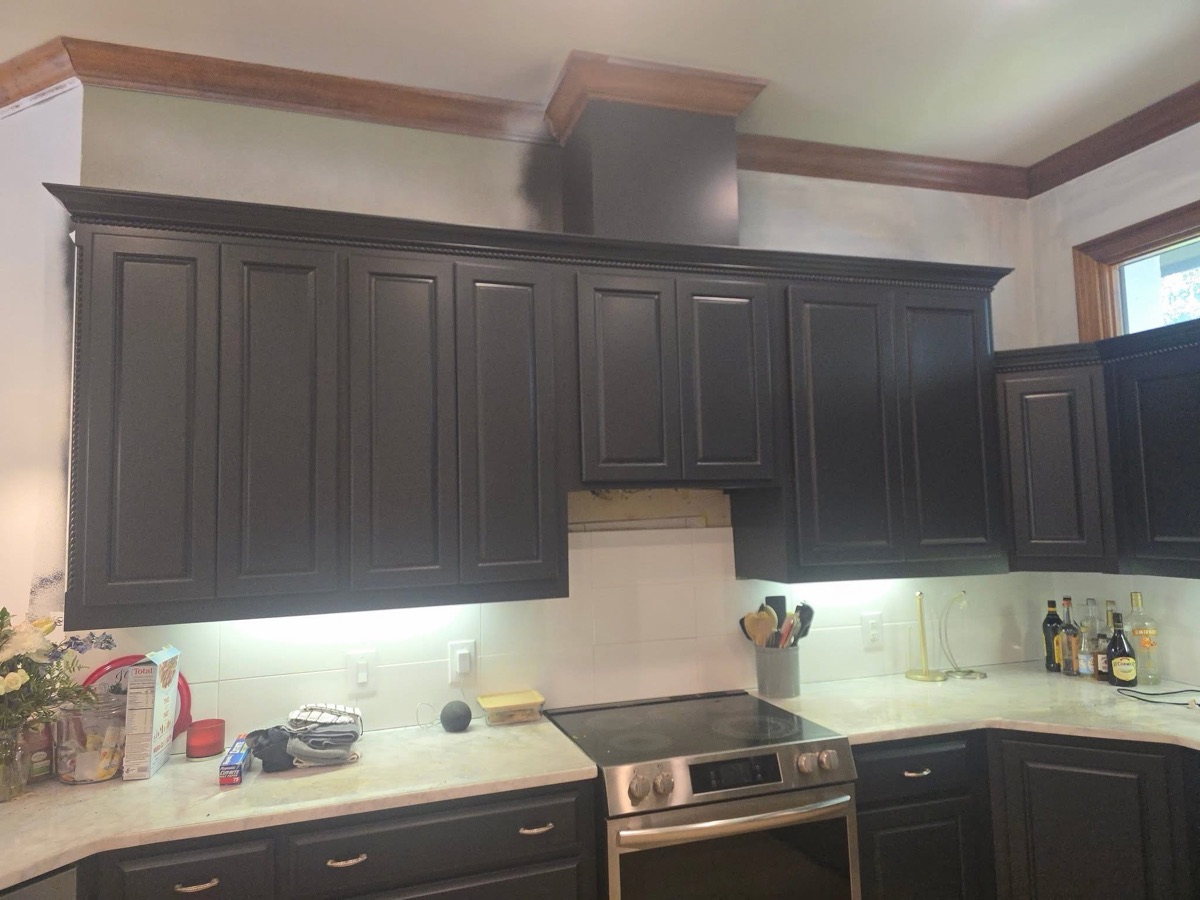 Kitchen refinished in charcoal with marble countertops and stainless appliances